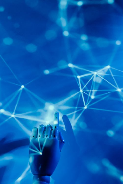 A robotic hand pointing at a glowing blue neural network, symbolizing artificial intelligence analyzing complex biological data.